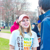 A young woman wearing the vibrantly-printed t-shirt outside.